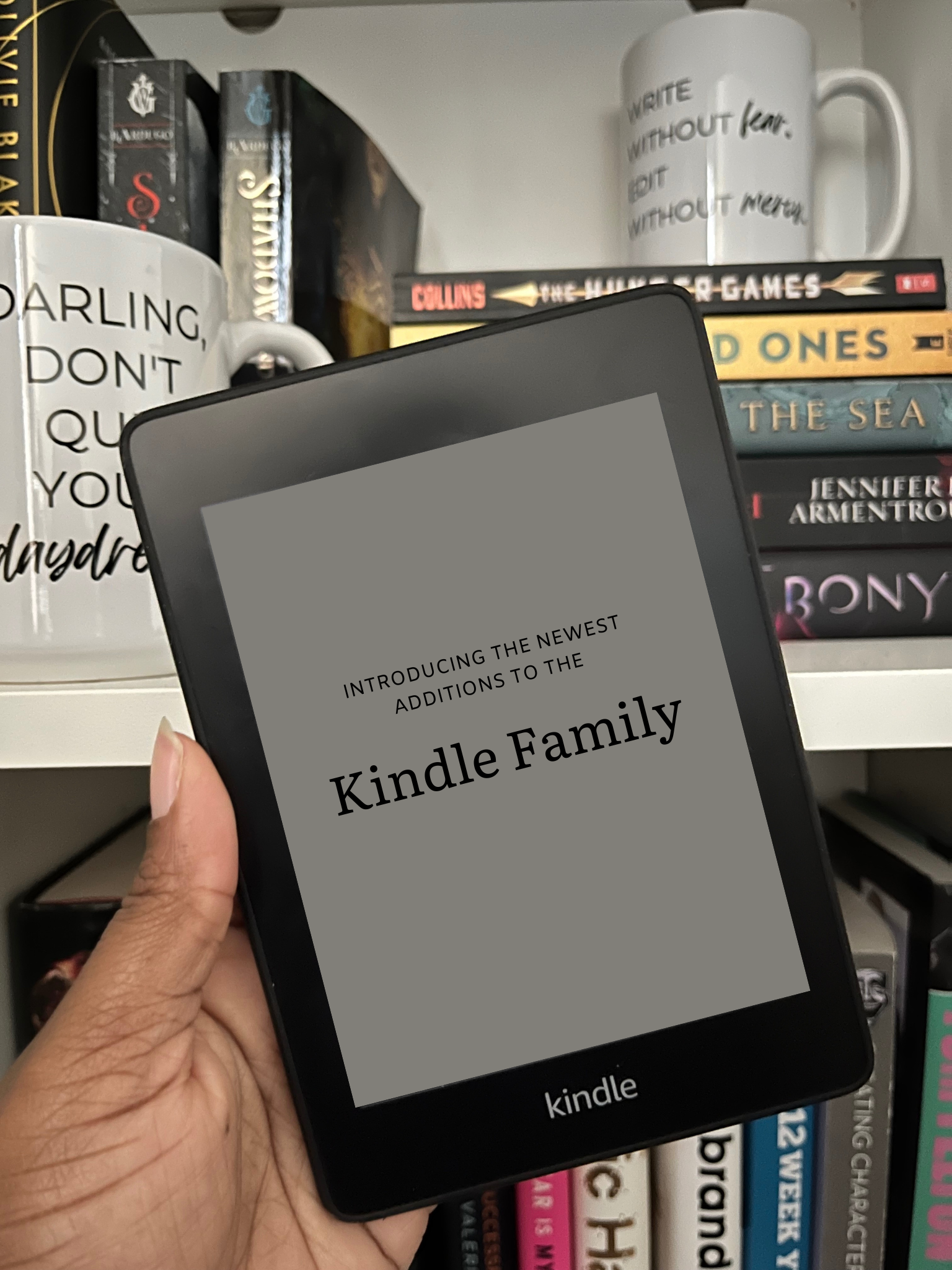 Kindle Paperwhite being held in front of a bookshelf